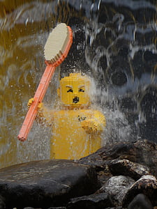 yellow toy brick on brown rock thumbnail