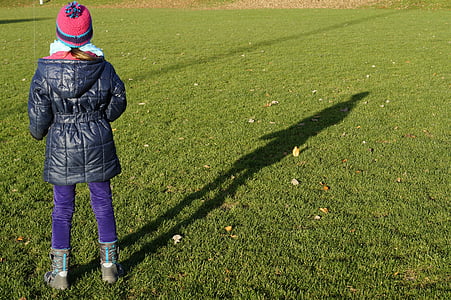 person standing on green grass field thumbnail