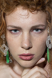 shallow focus photography of woman wearing silver earrings thumbnail