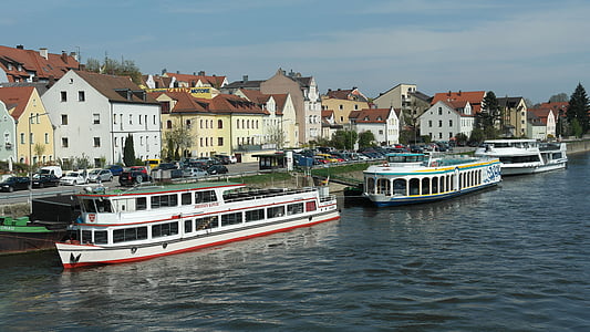 two ship on body of water near building under blue sky thumbnail