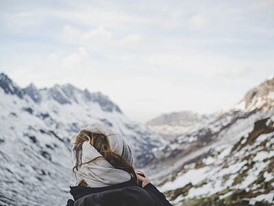 Person Wearing Black Jacket in Front of Mountain Filled With Snow thumbnail