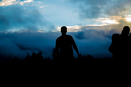 silhouette photo of man under blue sky thumbnail