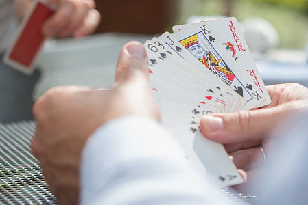 person holding playing cards thumbnail