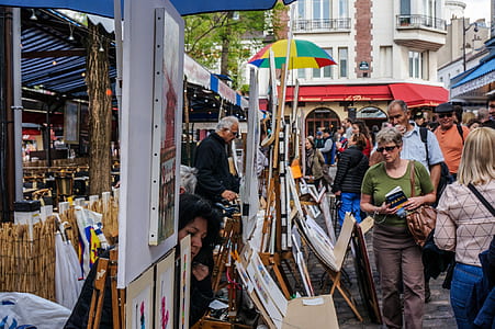 group of people crossing on street with painting stands thumbnail