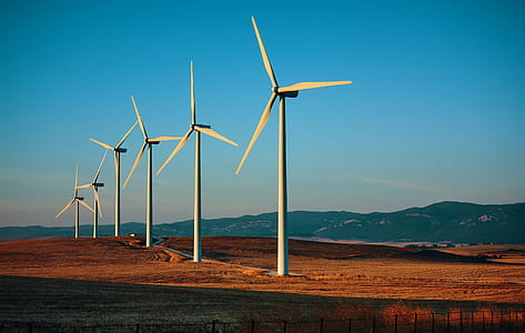 six white wind mills on landscape field thumbnail