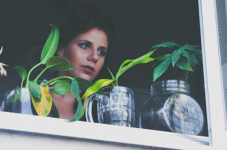 woman looking outside window thumbnail
