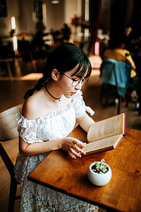 woman reading sitting on chair thumbnail