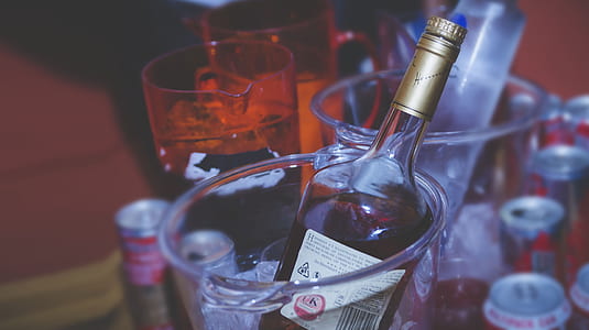 wine bottle on glass pail filled with ice thumbnail