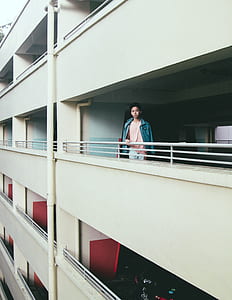 man standing on white building thumbnail
