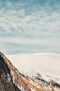 snow covered mountain under cloudy sky thumbnail