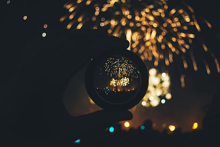 shallow focus photography of round prism with fireworks background thumbnail