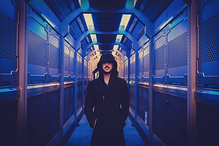 man wearing black hoodie standing on hallway thumbnail