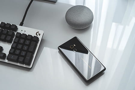 black Android smartphone and Google home speaker thumbnail