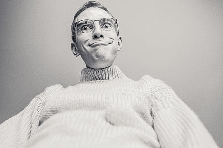 grayscale photo of man wearing knit sweater and eyeglasses thumbnail