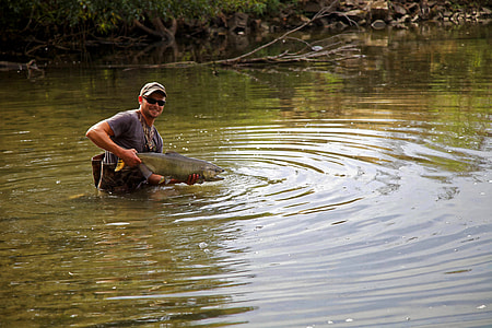 man holding fish thumbnail
