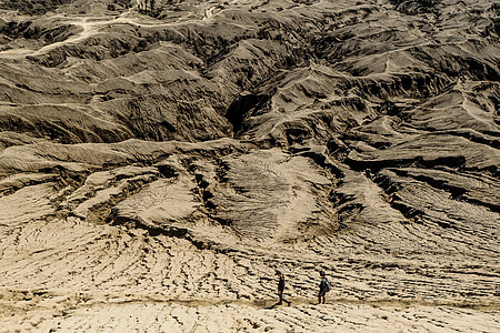 two person walking on brown mountain thumbnail
