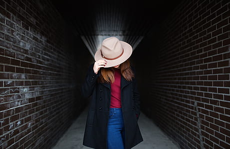 woman in black jacket and beige hat in hallway thumbnail