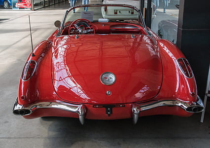 red coupe on sidewalk thumbnail