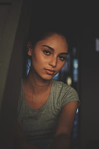 woman wearing gray scoop-neck cap-sleeved shirt inside room thumbnail