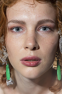 woman with silver and green beaded chandelier earrings thumbnail