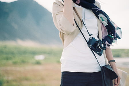 woman in white top and brown cardigan thumbnail