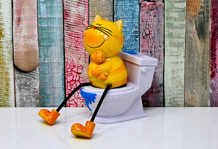 yellow cat sitting on toilet bowl figurine thumbnail
