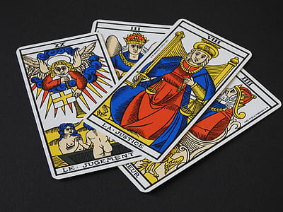 four assorted tarot cards on black surface thumbnail
