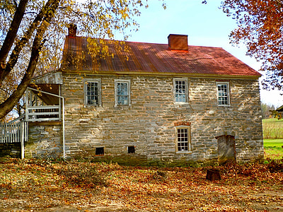 gray brick house surrounded with trees thumbnail