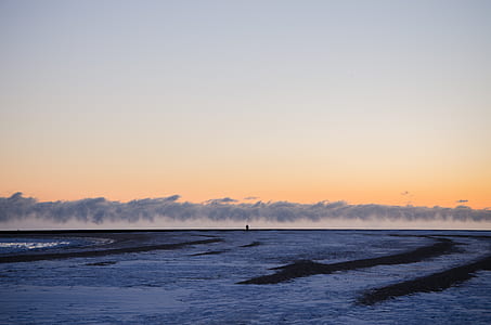 person standing on plain covered with snow thumbnail