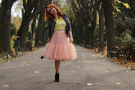 women's wearing black jacket and pink skirt thumbnail