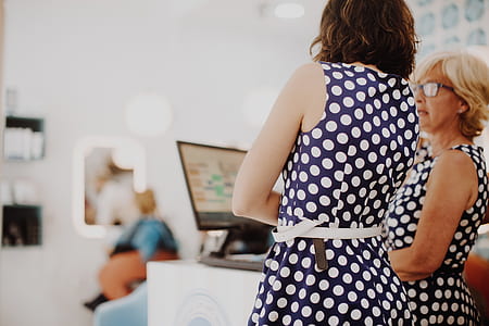woman wearing white and blue polka-dot sleeveless dress thumbnail
