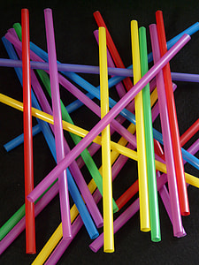 assorted-color straws on black surface thumbnail