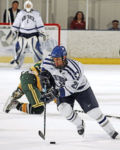 male ice hockey player skating together with puck thumbnail