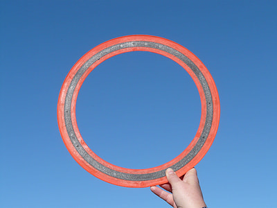 person holding round red metal ring thumbnail