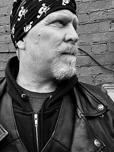 grayscale photography of man in leather jacket thumbnail