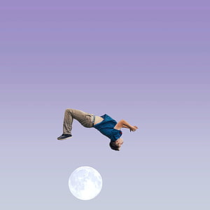 man in blue shirt and brown pants above moon thumbnail
