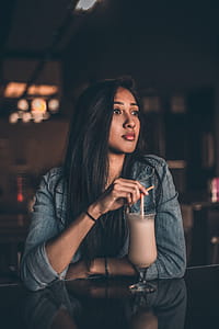 Woman Leaning on Table Having A Drink thumbnail