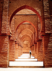 person in white shirt and brown pants standing on hallway thumbnail
