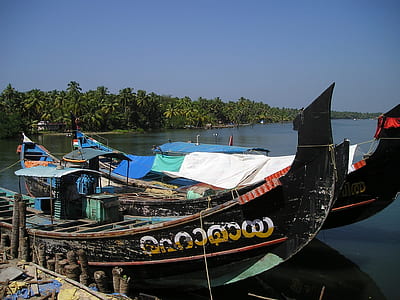 three black gondola beside wooden dock thumbnail