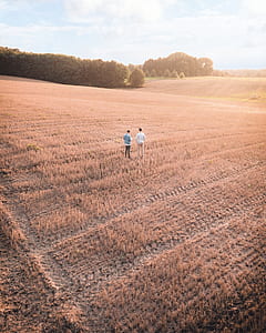 two man standing in the middle of the field thumbnail