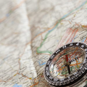 round black compass on map thumbnail