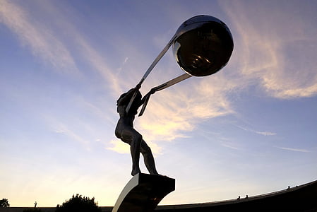 person holding strap with ball statue thumbnail