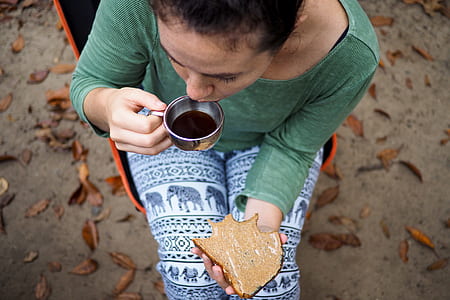 high-angle photography of woman about to drink a coffee thumbnail