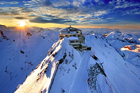 gray and white house on top on snowy mountain thumbnail