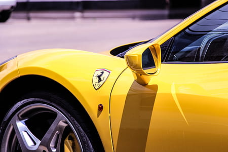 yellow Ferrari car during daytime thumbnail