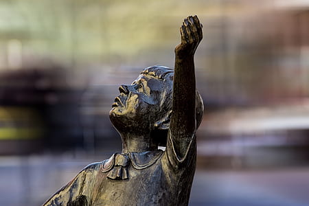 selective focus photo of boy statue during daytime thumbnail