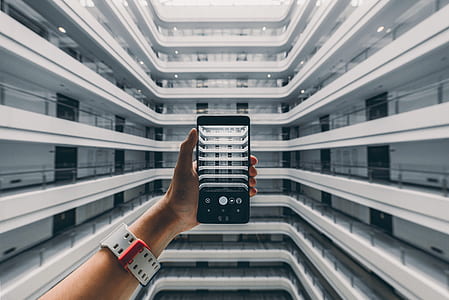 person taking photo of hallway thumbnail