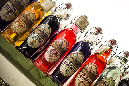 assorted-color bottles on green table thumbnail