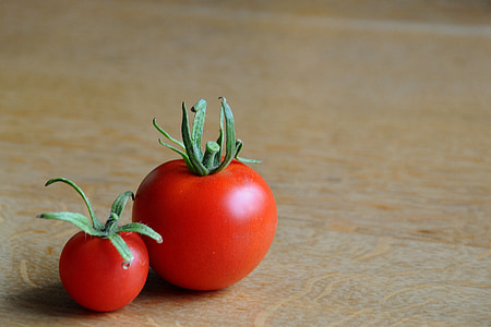 two red tomatoes on brown surface thumbnail