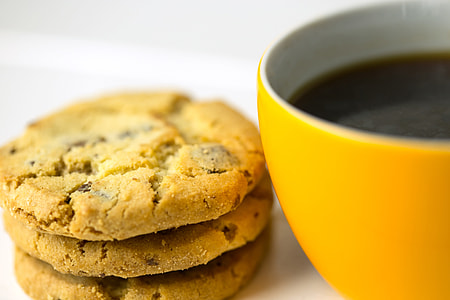 Closeup shot of yellow coffee cup and cookie biscuits. Image captured with a Canon 6D DSLR thumbnail